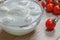 Mozzarella cheese in a transparent bowl and cherry tomatoes
