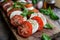 Mozzarella and tomato salad. Fresh italian caprese salad with mozzarella and tomatoes on wooden board