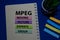 MPEG - Moving Picture Experts Group acronym write on sticky note isolated on Office Desk