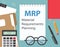 MRP Material Requirements Planning written in notebook on office desk