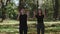 MS Boy and girl jumping and throwing dry leaves in park