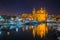 Msida, Malta - The beautiful Msida Parish Church with yachts and boats and reflection on the water by night