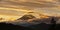 Mt Rainier at sunset with golden clouds