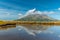 Mt. Taranaki reflected on a pond during a sunny day at New Zealand