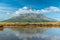 Mt. Taranaki reflected on a pond during a sunny day at New Zealand