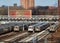 MTA Coney Island train yard with several parked nyc trains and skyscrapers visible in the background