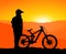 MTB / Mountain bike Downhill Backflip in the Mountains, landscape with the setting sun behind the mountains. without spokes at th