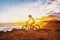 MTB mountain biking cyclist woman rider riding bike on summer coastal trail sunset landscape. Girl silhouette of athlete