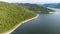 Muak Lek reservoir in Saraburi from aerial bird eye view. Beautiful unseen nature at Muak Lek dam with roadway beside with water a