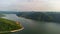 Muak Lek reservoir in Saraburi from aerial bird eye view. Beautiful unseen nature at Muak Lek dam with roadway beside with water a