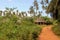 Mud huts in a rural village along a dust road