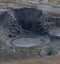 Mud pools with crater in the geothermal area of Hverir, Iceland