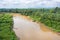 Muddy brown jungle stream meanders through the untouched Rain forest at Bentong, Pahang, Malaysia. Aerial view of a river in the