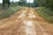 Muddy and destroyed dirt road after rain