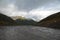 Muddy dirt road over a mountain pass