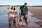 Muddy family playing on beach