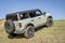 Muddy Ford Bronco Sport SUV on a grassy hill