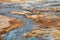 Muddy hot pools and textured sulfur ground in Icelandic geothermal