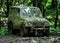 Muddy military jeep in forest