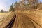 Muddy path by the forest. Muddy terrain. Country road in the Czech Republic. Spring morning in the countryside