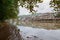 Muddy riverside in cloudy autumn morning after night overflowing