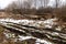 Muddy road across frozen land.