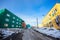 Muddy road with snow and living blocks with long low buildings in  Ilulissat city, Greenland