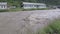 Muddy water flow in the river bed during the flood after heavy rains in the Sayan mountains in the river valley