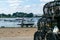 Mudeford Quay, United Kingdom - 16 July 2020: Two fishermen comming back from the sea fishing, taking the boat on dry land and