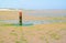 Mudflat with red beach pole marking coastline, Netherlands