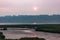 mudflats and wetlands under sunset in hazy smoke filled skys