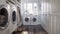 a mudroom with a head-on shot featuring side-by-side white washer and dryer units, exuding modern functionality and