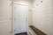 Mudroom interior with white door to the garage and wood panel interior