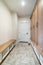 Mudroom interior with white fire door and a flooring with herringbone pattern