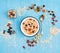 Muesli, berries with nuts and seeds in bowl on blue rustic background. Healthy food, Diet, Detox, Clean Eating or Vegetarian