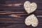 Muesli in bowl heart shaped on dark natural wooden board background. Raw oatmeal. Empty place, copy space for text