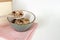 Muesli breakfast, oatmeals in ceramic bowl with wood spoon. Healthy food. Copy space text