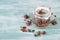 Muesli with chocolate in a glass on a turquoise blue and white shabby background, empty space for text