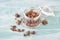 Muesli with chocolate in a glass on a turquoise blue and white shabby background, empty space for text