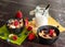 Muesli with fresh berries in black bowls.