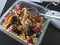 Muesli with fruits, nuts and oatmeal on writing desk
