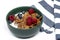 Muesli, isolate on white. Breakfast, healthy food and diet. Muesli with fruits and milk in a plate. Blueberries