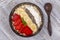 Muesli made from red strawberries, banana, chia seeds, oat flakes, honey and dressed with yogurt