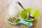Muesli in plastic spoon, jug of milk, empty bowl