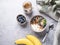 Muesli with vegetarian yogurt, banana and blueberries in a bowl on a gray texture background. Healthy and dietary homemade granola