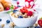 Muesli with yogurt and berries on a wooden table. Healthy fruit and cereal brakfast