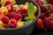 Mueslis with berries in a black  cup on the table, macro