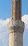 A muezzin singing his prayer on a Minaret.