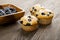 Muffin with blueberries on a wooden table. fresh berries and sweet pastries on the board