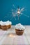 Muffin with burning flare, sparkling and white cream icing